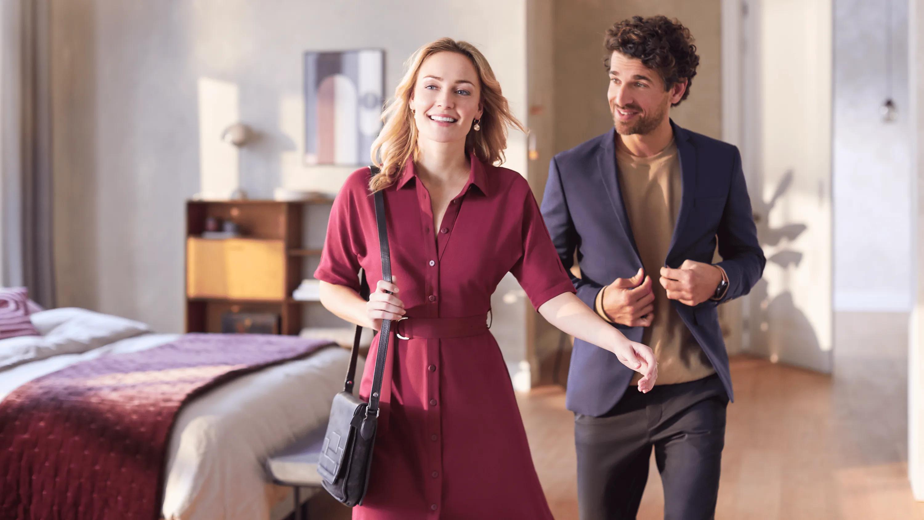 Smiling couple in fresh wrinkle-free clothes, highlighting results of Philips PerfectCare 8000 Series steam generator ironing.