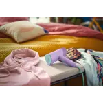 Garment Care Simba Handheld-Steamer Product In Use Photo (PPL) STH3010_70 (Purple color) V0.jpg. RGB Garment Care Simba Handheld-Steamer Product In Use Photo (PPL) STH3010_70 (Purple color) V0.jpg. RGB
