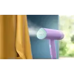 Garment Care Simba Handheld-Steamer Main in-use photograph (PPL) STH3010_70 (Purple color) V0.jpg. RGB Garment Care Simba Handheld-Steamer Main in-use photograph (PPL) STH3010_70 (Purple color) V0.jpg. RGB